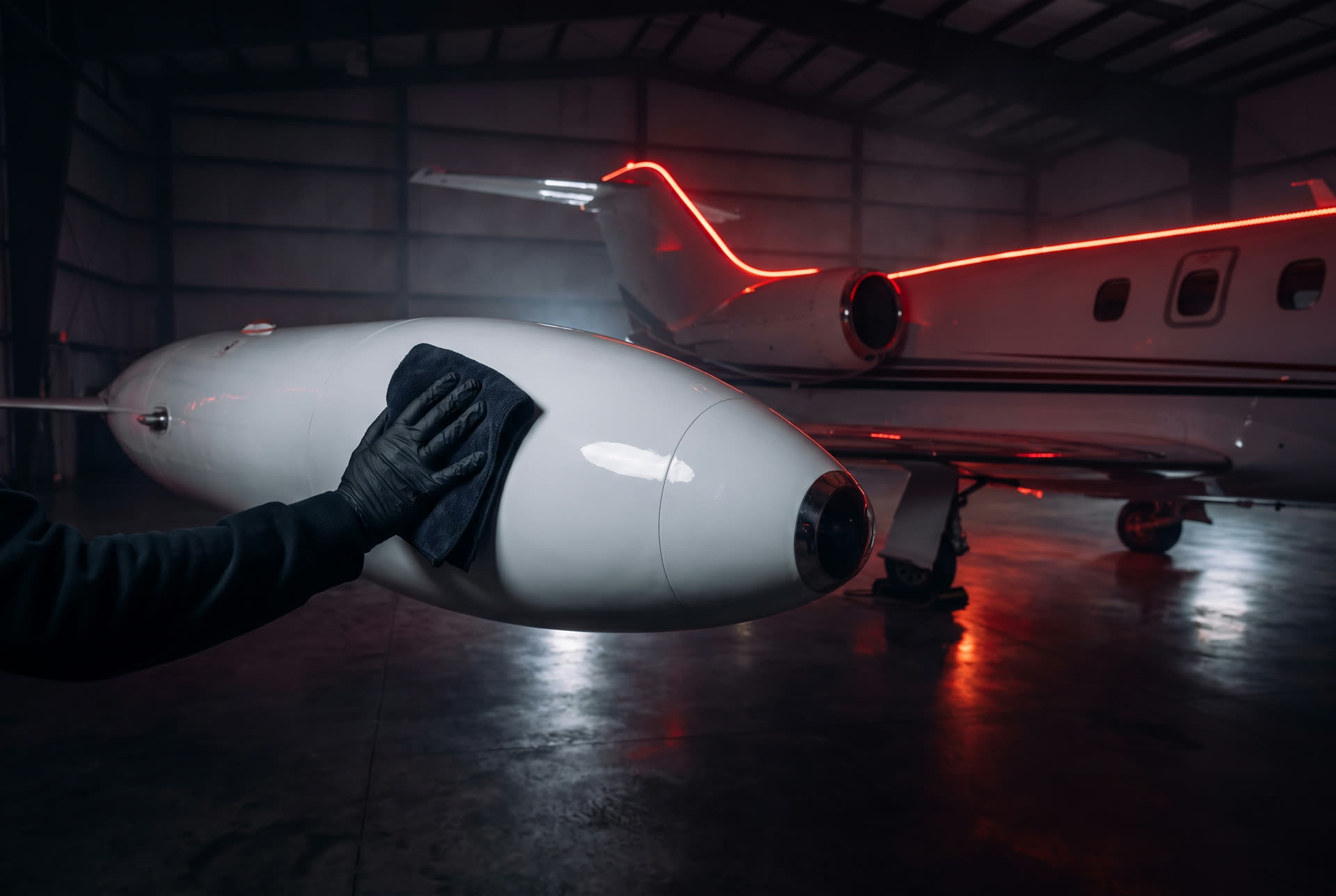 Polishing a light jet engine nacelle in a dark hangar